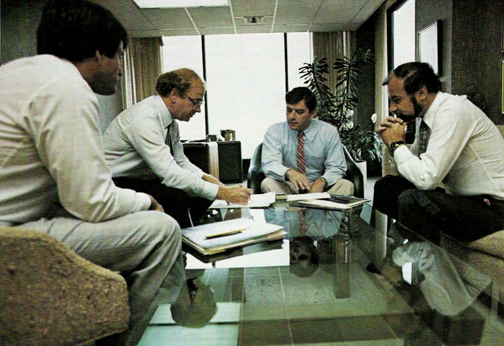 A meeting of Comshare executives, left to right; Joe Blumberg, Vice-President of Human Resources and Administration; Wally Wrathall, Group Vice-President 0f Finance and Administration; Richard Crandall, President of Comshare; and Kevin Kalkhoven, Group Vice-President.