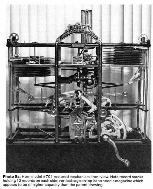 Horn model #701 restored mechanism, front view. Note record stacks holding 12 records on each side; vertical cage on top is the needle magazine which appears to be of higher capacity than the patent drawing.